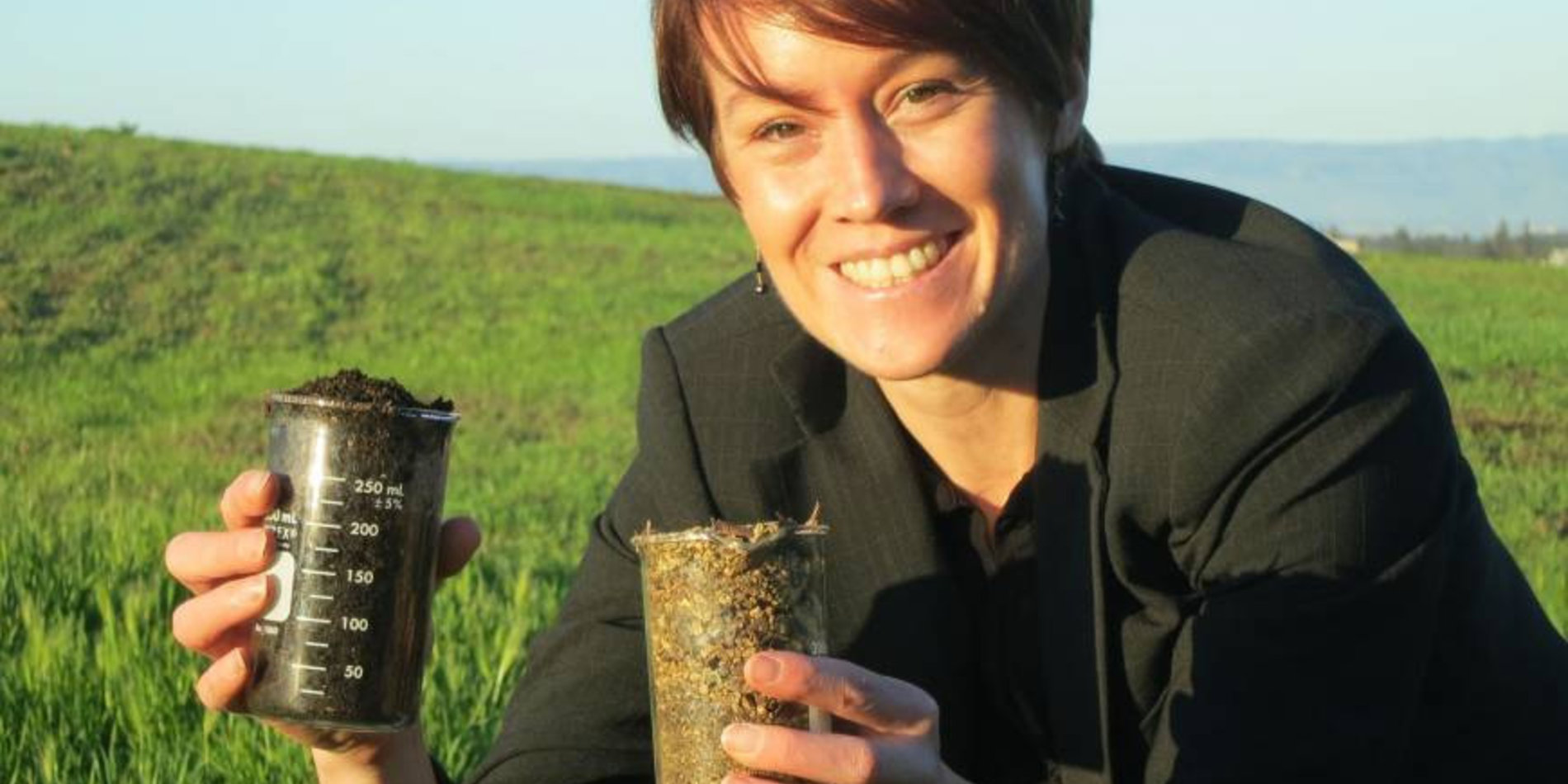 Kate Maher holding containers of soil 