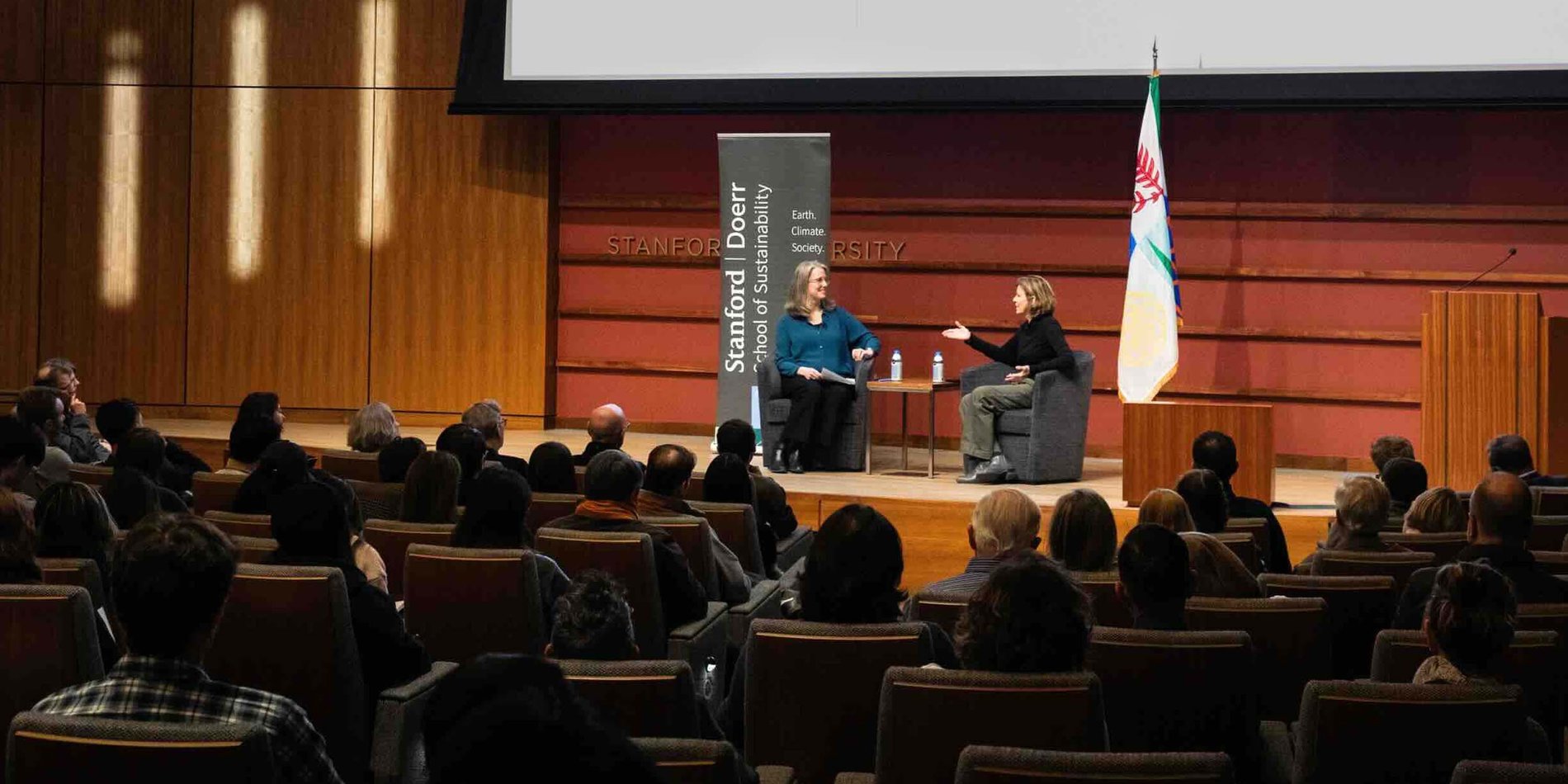 Wide angle of an auditorium with Jeanne Gang talking to Sarah Billington on stage