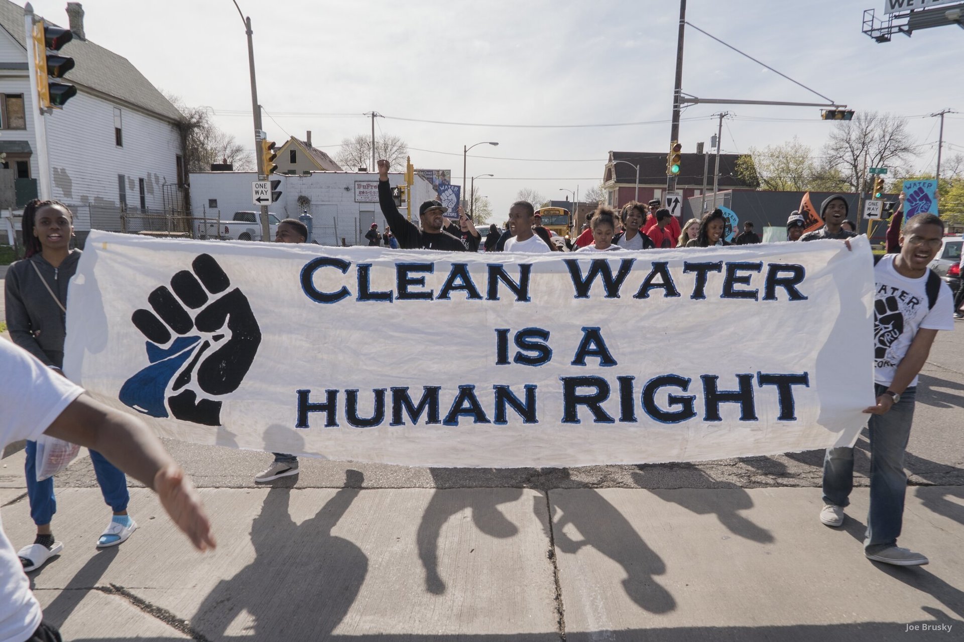 Protestors holding sign that reads clean water is a human right