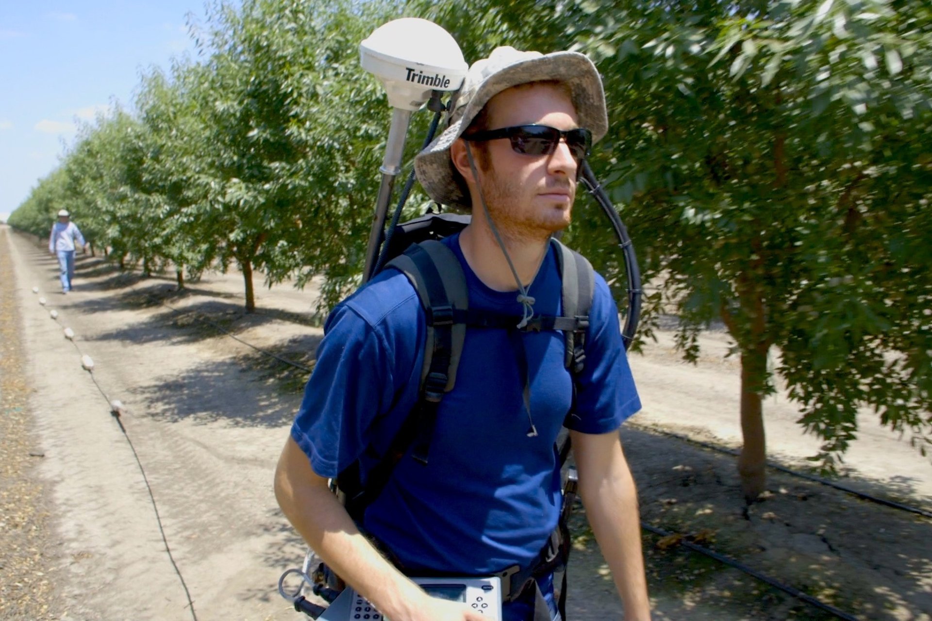Student collecting data on farm.