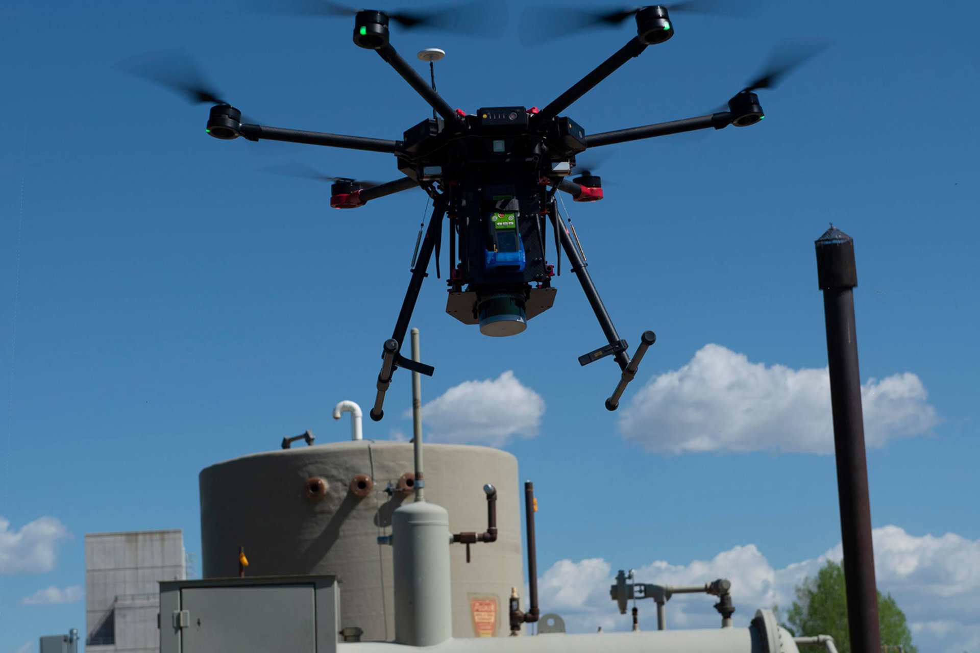 Drone hovering above oil refinery