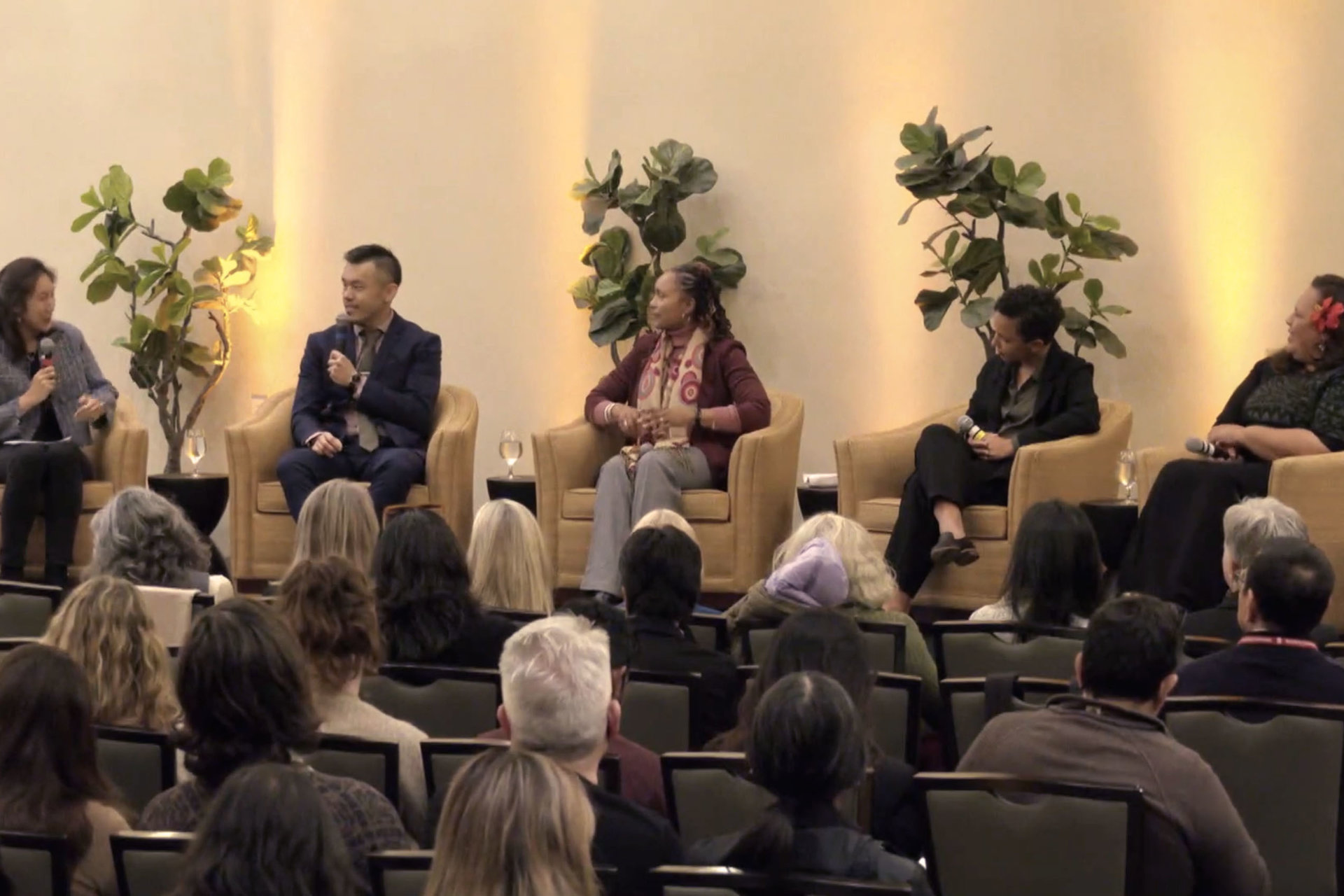 Five people on stage participating in a panel discussion