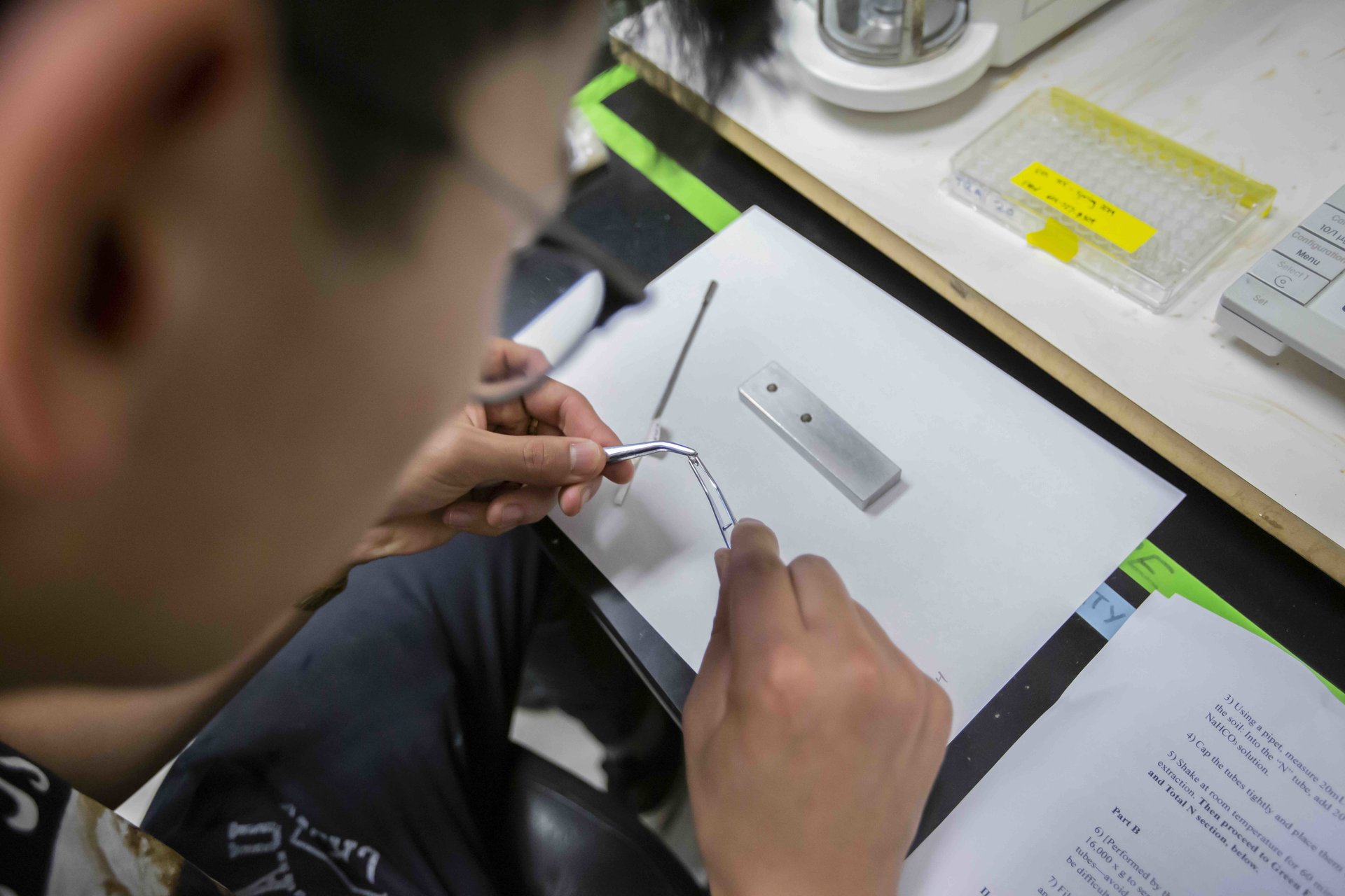 Close-up of a student working with a research tool
