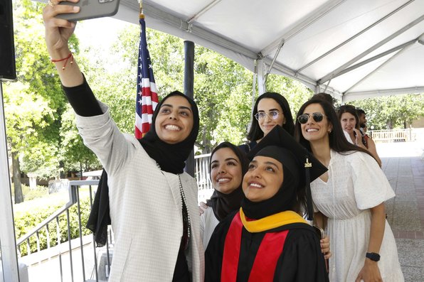 A graduating student and their family and friends taking a selfie
