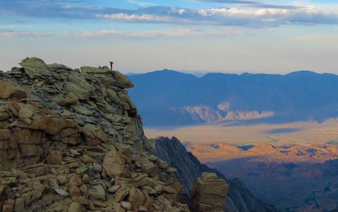 Student standing atop mountain
