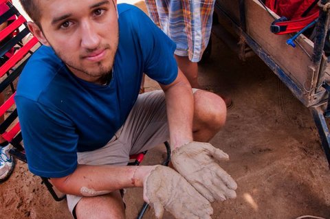 Student with muddy hands