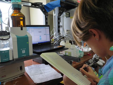 Former undergrad (and first year E-IPER PhD student), Meghan Shea, troubleshoots our total alkalinity robotitrator in the lab, Palau International Coral Reef Center.
