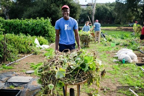 Student pushing a wheelbarrow