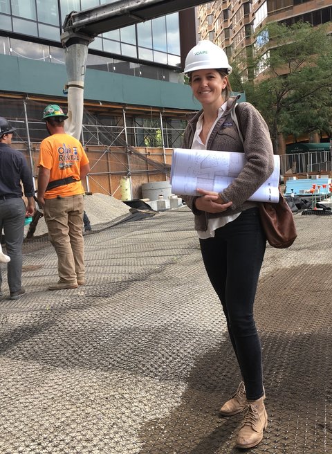 Kate Hayes in hard hat holding blueprint