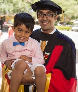 Graduate holding a boy