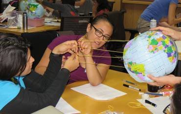 Teachers use string to model sunlight hitting Earth's surface