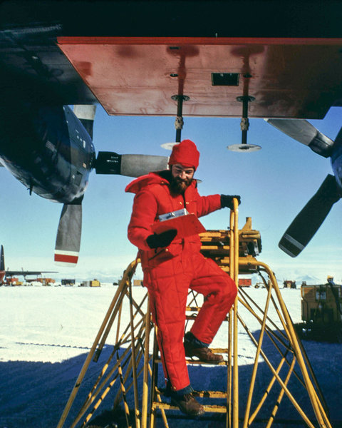 Nils Sko checking on radar antenna on c-130 plane