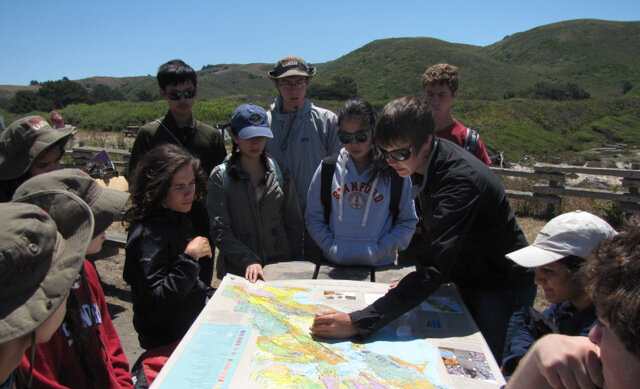 Students looking at a map in the field