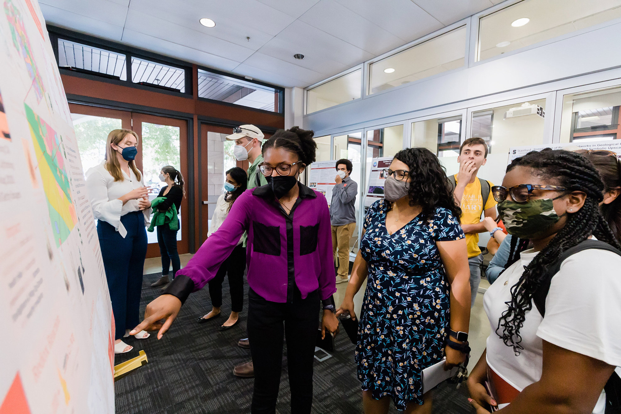 Diverse students discussing scientific posters