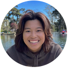 Raisha Abubo smiling outside at a lake